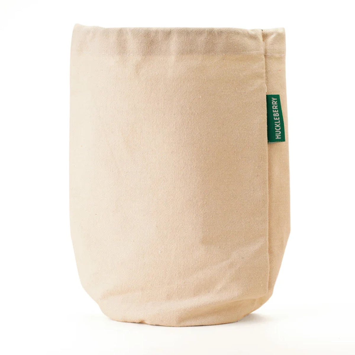 Huckleberry Hideaway natural canvas cotton storage bag with green brand label on white background.