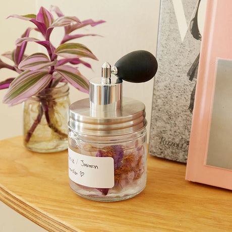 Huckleberry make your own perfume kit glass jar with dried flowers silver atomizer on wooden shelf.