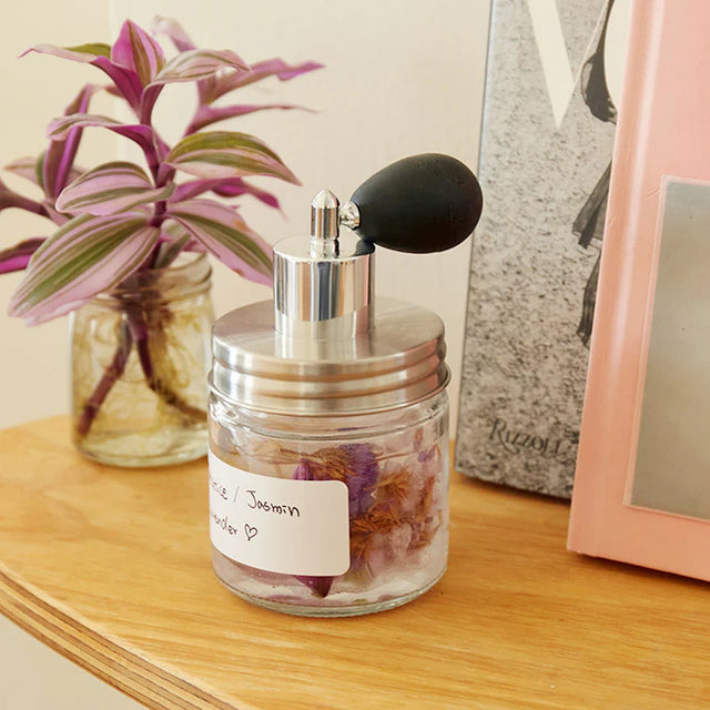 Huckleberry make your own perfume kit glass jar with dried flowers silver atomizer on wooden shelf.