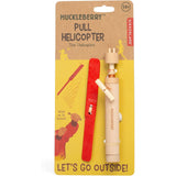 Huckleberry Pull Helicopter by Kikkerland in yellow packaging, featuring a red wooden blade and launcher tool.