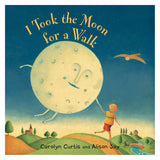 Book cover of "I Took the Moon for a Walk" showing a boy walking a large, smiling moon on a string over rolling hills.