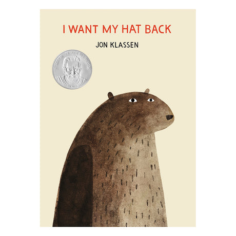 Cover of "I Want My Hat Back" by Jon Klassen. A large brown bear looks to the right with a neutral expression. A medal sticker is on the left.