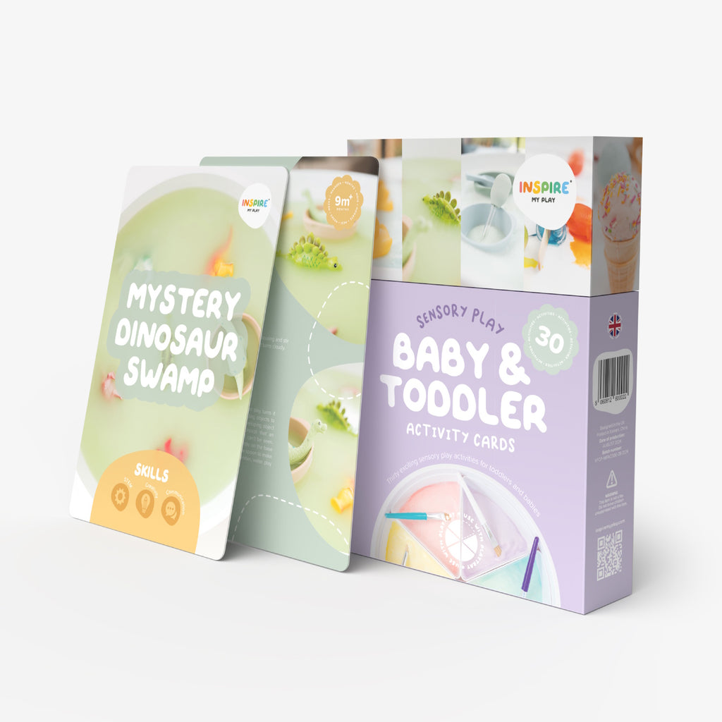 Box of "Baby & Toddler Activity Cards" for sensory play. Features playful design, pastel colors, rubber duck, paint, and crafting materials.