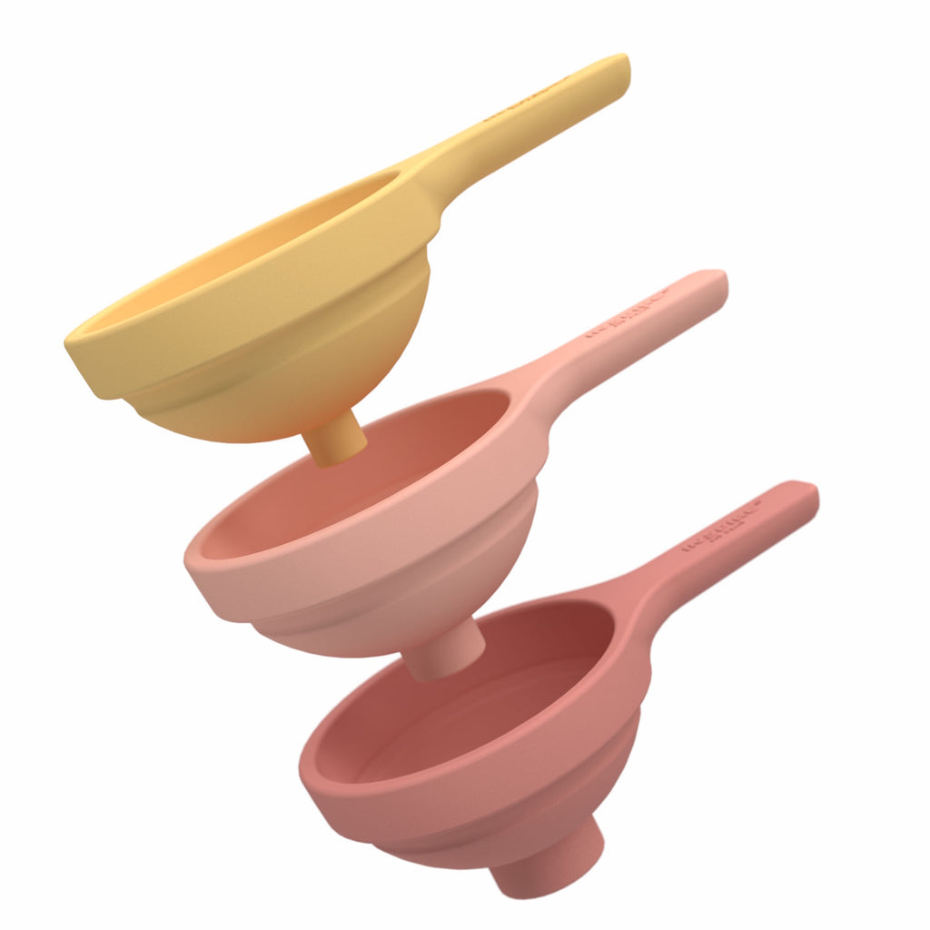 Three nested silicone funnels in pastel colors coral and yellow, stacked vertically. They convey a neat, organized kitchen accessory setup.