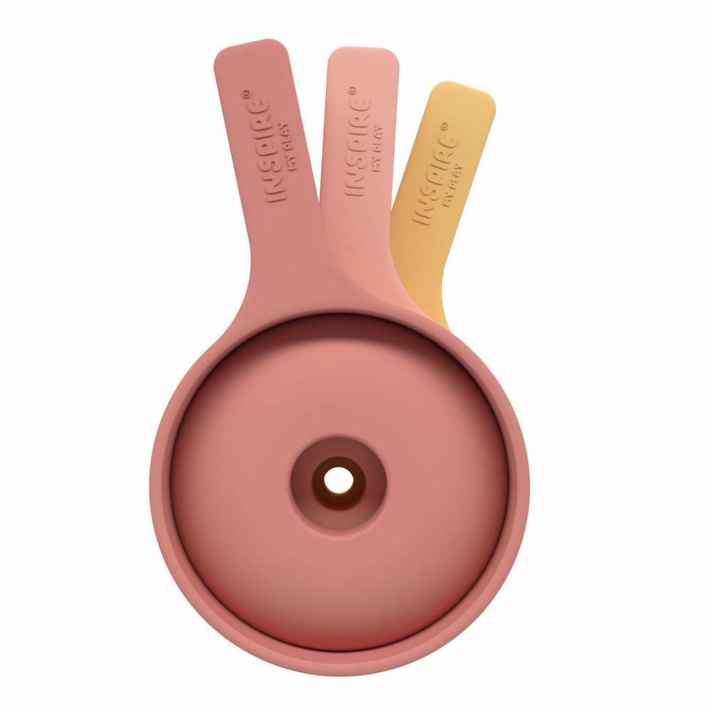 Three nested silicone funnels in pastel colors coral and yellow, stacked vertically. They convey a neat, organized kitchen accessory setup.