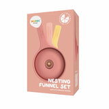 Box containing a nesting funnel set of three pastel-colored silicone funnels, coral and yellow, against a matching pink background.