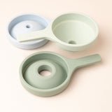 Three stackable silicone funnels in pastel blue and green, showcasing a minimalist and practical design.