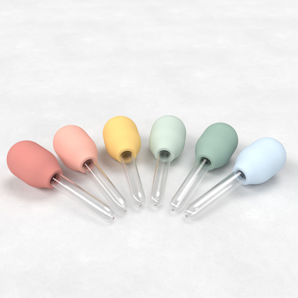 Colorful bulb-shaped dropper tops with pastel hues—red, pink, yellow, green, blue—attached to clear glass pipettes.