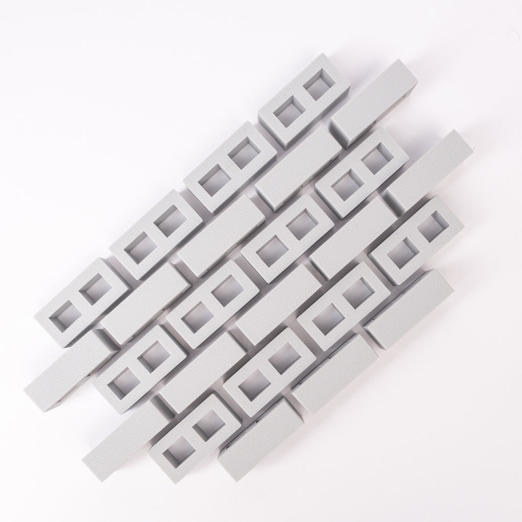 Abstract geometric pattern of interlocking gray rectangular blocks on a white background. The design is orderly and conveys a modern, minimalist aesthetic.