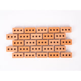 Silicone mini bricks, each brick is terracotta-colored with round holes, conveying a playful tone.