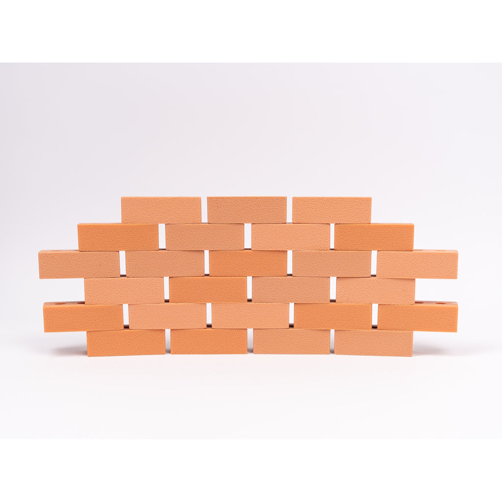 Silicone mini bricks, each brick is terracotta-colored with round holes, conveying a playful tone.