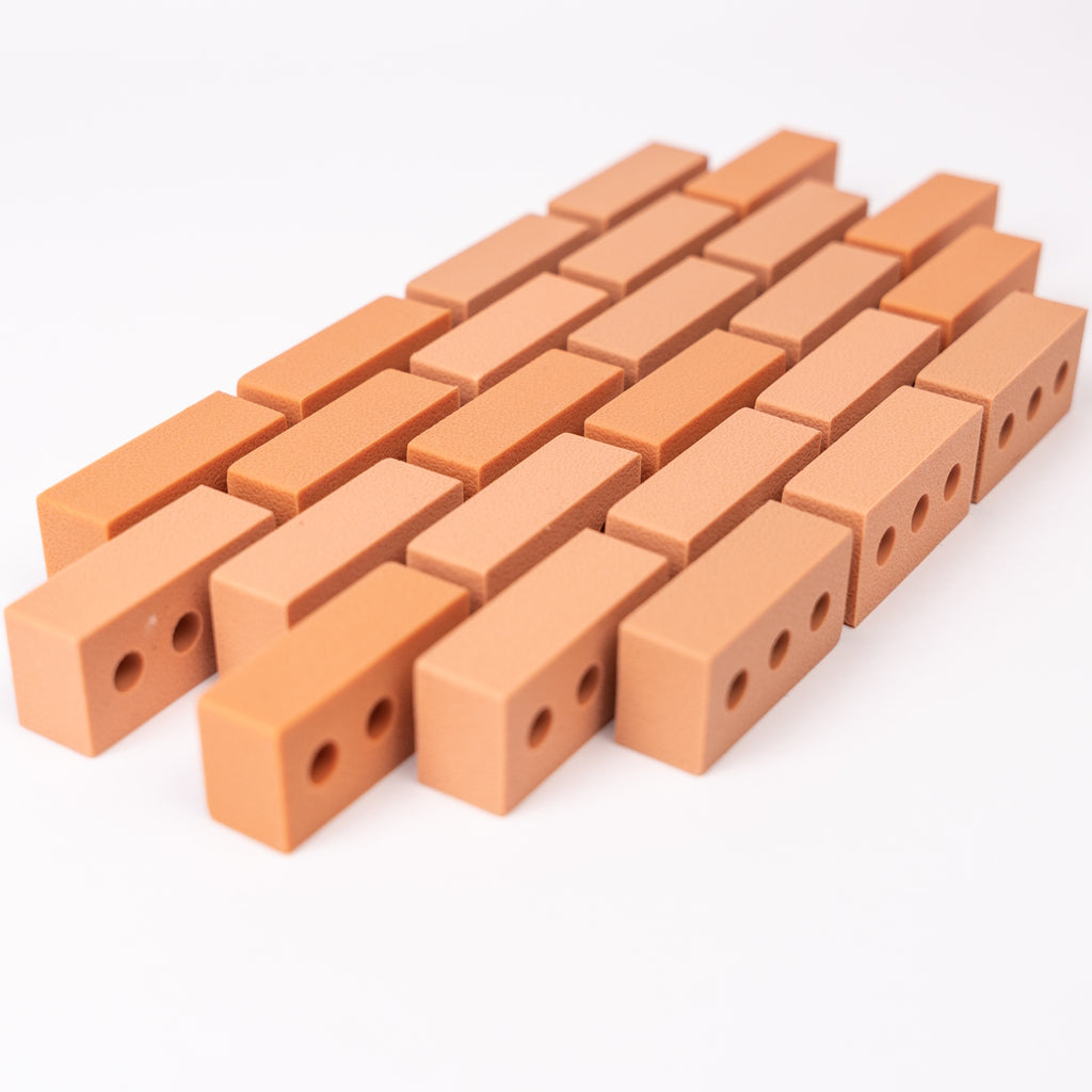 Silicone mini bricks, each brick is terracotta-colored with round holes, conveying a playful tone.