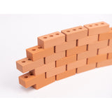 Silicone mini bricks, each brick is terracotta-colored with round holes, conveying a playful tone.