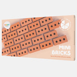 Packaging for "Mini Bricks" by Inspire My Play shows rows of small, orange silicone bricks with three holes. Text highlights a set of 25 bricks for play.