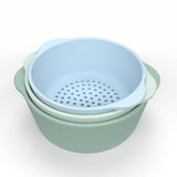 Three nested bowls in pastel colors: pale blue, mint green, and sage. The top blue bowl is perforated, suggesting it's a colander.