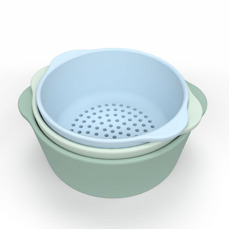 Three nested bowls in pastel colors: pale blue, mint green, and sage. The top blue bowl is perforated, suggesting it's a colander.