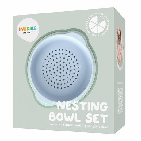 Packaging for a "Nesting Bowl Set" with a cute, pastel blue silicone sieve visible. Labeled for use with play products, the design is playful and modern.