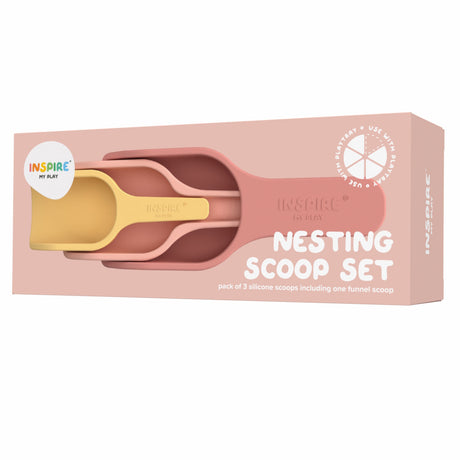 Packaging of a "Nesting Scoop Set" with three nested silicone scoops in muted pink and yellow. The box is blush pink, creating a calm, playful tone.