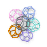 Jellystone Designs sensory balls arranged in a flower pattern with varied pastel and neutral colors.