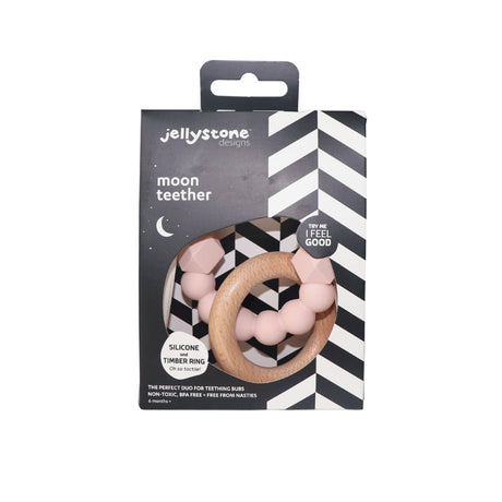 The Jellystone Moon Teether in blush pink, presented in sleek black-and-white chevron packaging with a clear window, highlighting its tactile silicone and timber textures.