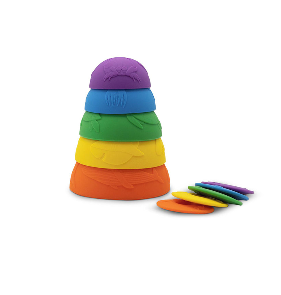 A colourful set of ocean-themed stacking cups in a rainbow gradient from orange to purple, neatly stacked with matching discs beside them.