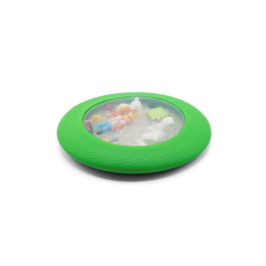 A green sensory peekaboo bag filled with tiny farm-themed toys and beads, designed for tactile exploration.