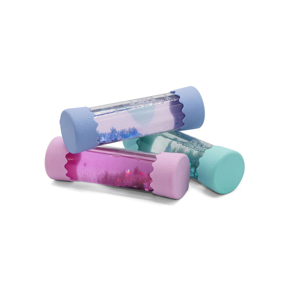 A set of three Jellystone Baby Calm Down Bottles in pastel blue, pink, and mint green, each filled with mesmerising swirling glitter and sensory elements.
