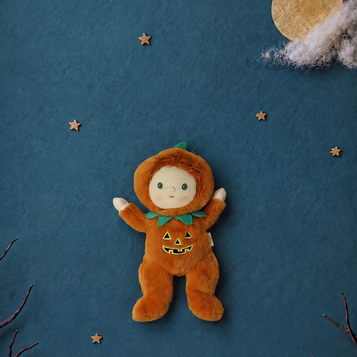 Plush doll in a jack-o'-lantern suit centered against a blue background with stars and a moon.