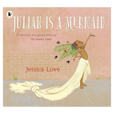 The book cover of "Julian is a Mermaid" depicts a child joyfully posing with an arm raised, draped in a white fabric resembling a mermaid tail, against a pink brick wall. Various flowers and leaves are tucked into the fabric. The tone is celebratory and whimsical.