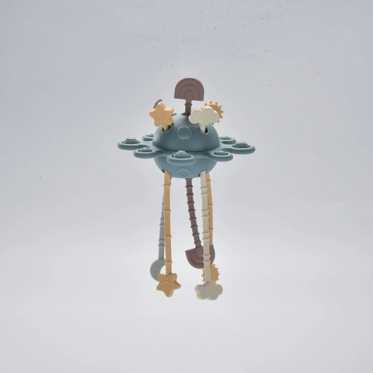 Blue silicone baby pull toy hanging in a front view.