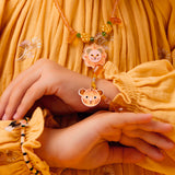 Child wearing Felindra tiger and lion bracelets from the kids yellow jungle collection jewelry line.