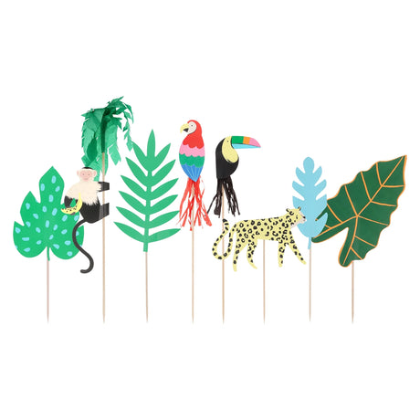 Jungle-themed paper cake toppers featuring a monkey, parrot, toucan, leopard, and various tropical leaves.