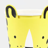 Close-up of a yellow animal-themed party cup with pop-out ears and black spots against a white background.
