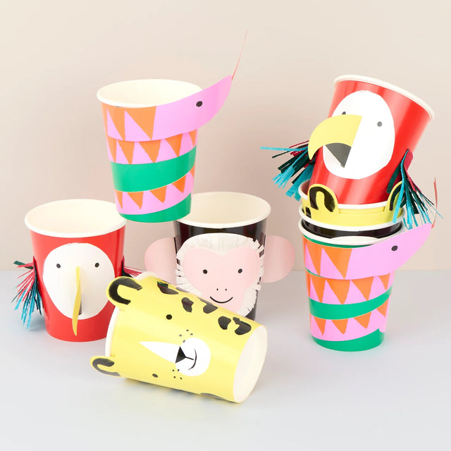 Stack of colorful paper cups decorated as jungle animals like monkeys, parrots, and tigers with paper cutouts.