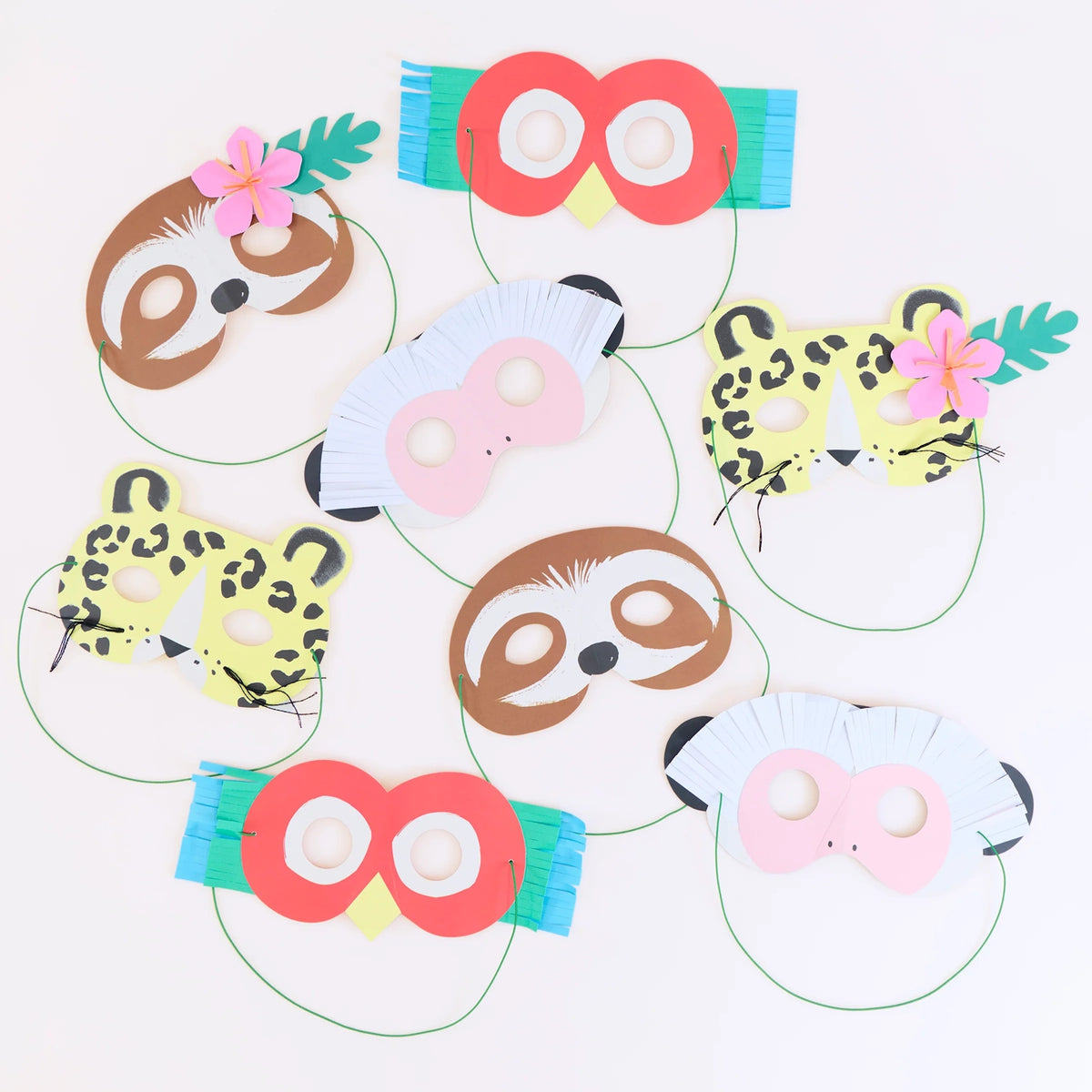 Hand-crafted colorful paper jungle animal masks, including a sloth, leopard, monkey, and parrot, with elastic.