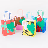 Four colorful jungle-themed gift bags featuring a lizard, sloth, monkey, and parrot with green leaf tags.