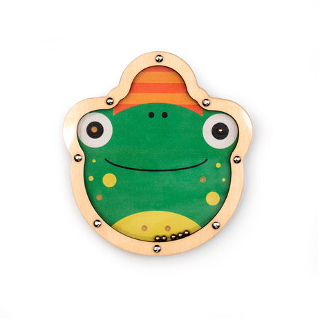 Cute frog illustration on a round, wooden toy with metal balls inside. The frog is green with big eyes, yellow spots, and a friendly smile.