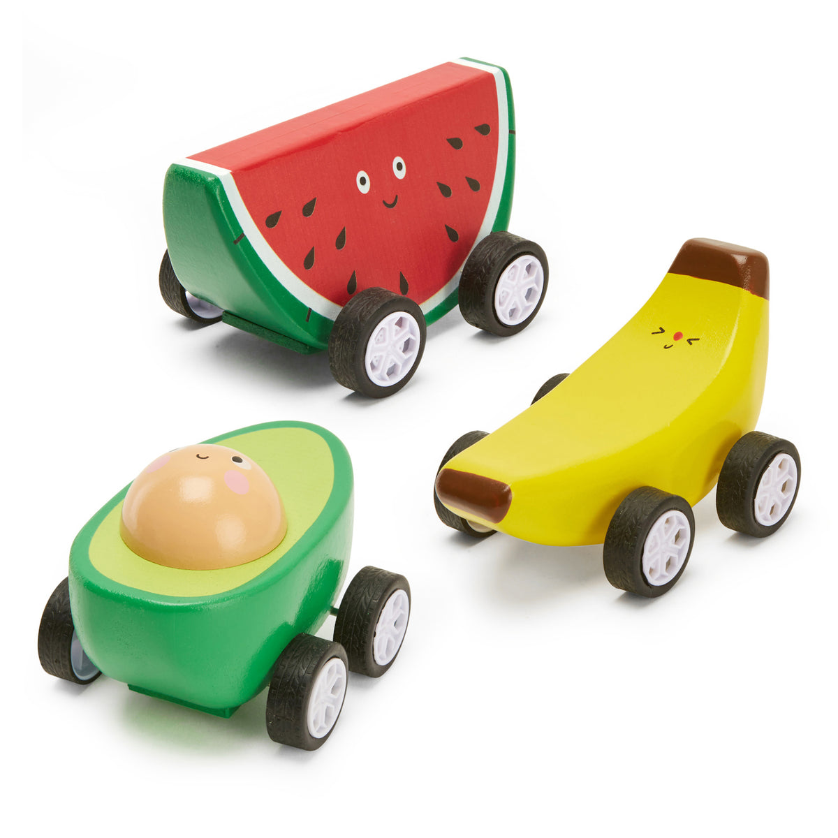 Wooden toy cars shaped like fruit: a smiling watermelon slice, a joyful banana, and a cheerful avocado. Each has cartoonish eyes and wheels.