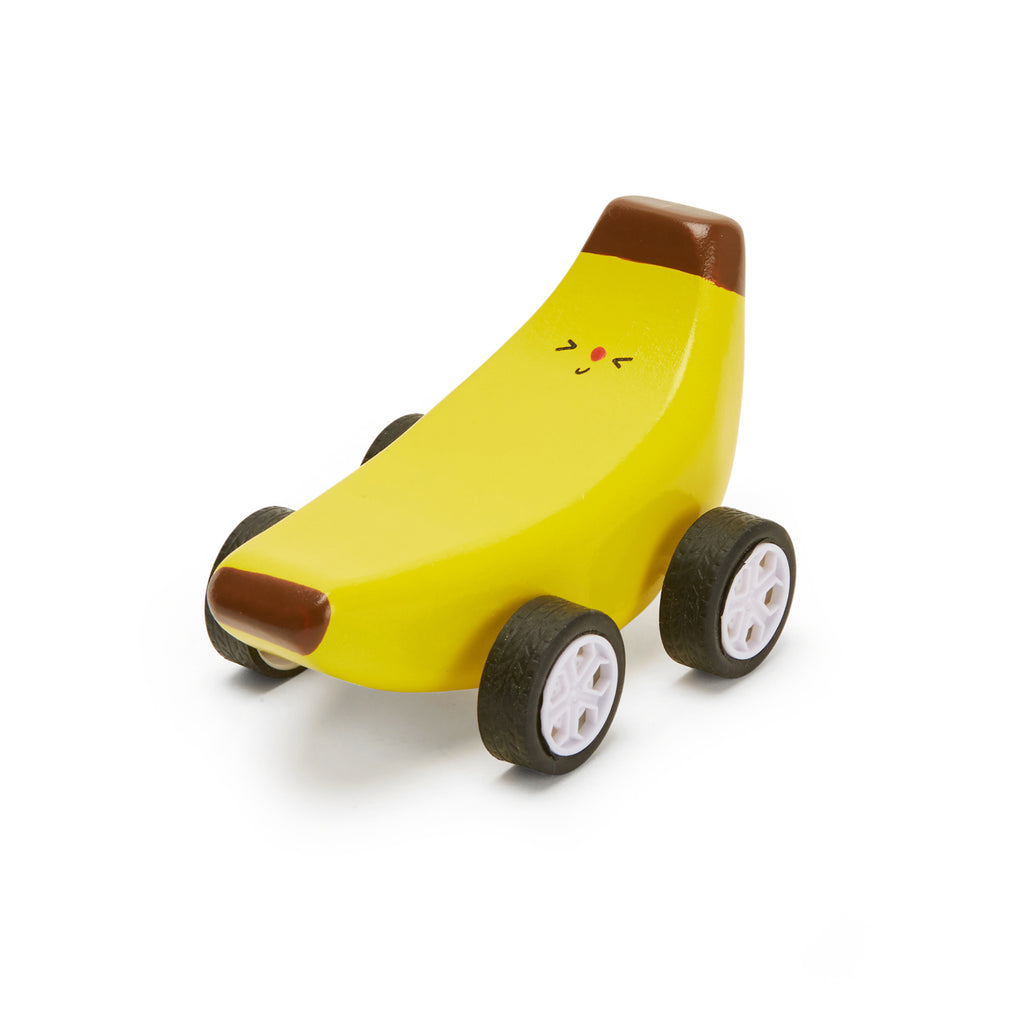 Whimsical yellow banana-shaped toy car with a smiling face, brown tips, and four wheels. It exudes a playful and cheerful vibe.