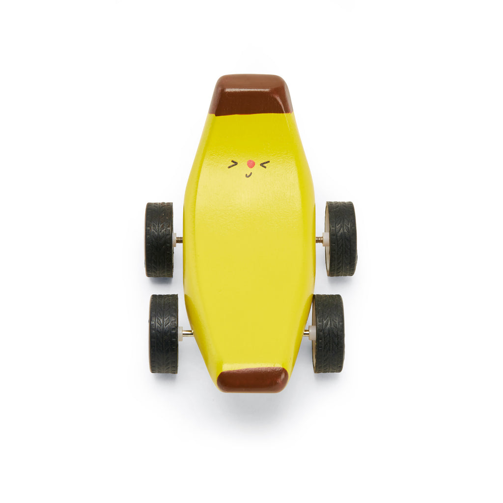 Whimsical yellow banana-shaped toy car with a smiling face, brown tips, and four wheels. It exudes a playful and cheerful vibe.