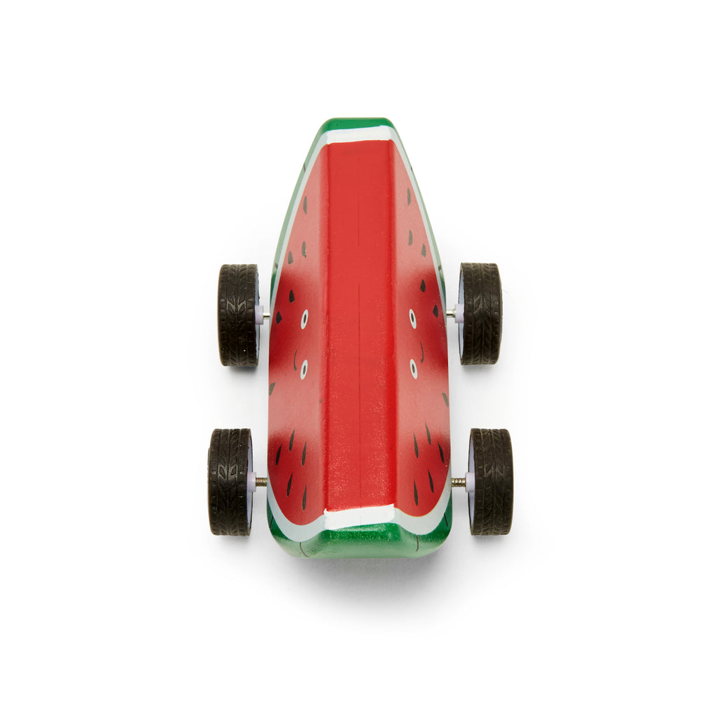 A wooden toy car shaped like a smiling watermelon slice with four wheels. It features a red and green design with painted black seeds, creating a playful and cheerful vibe.