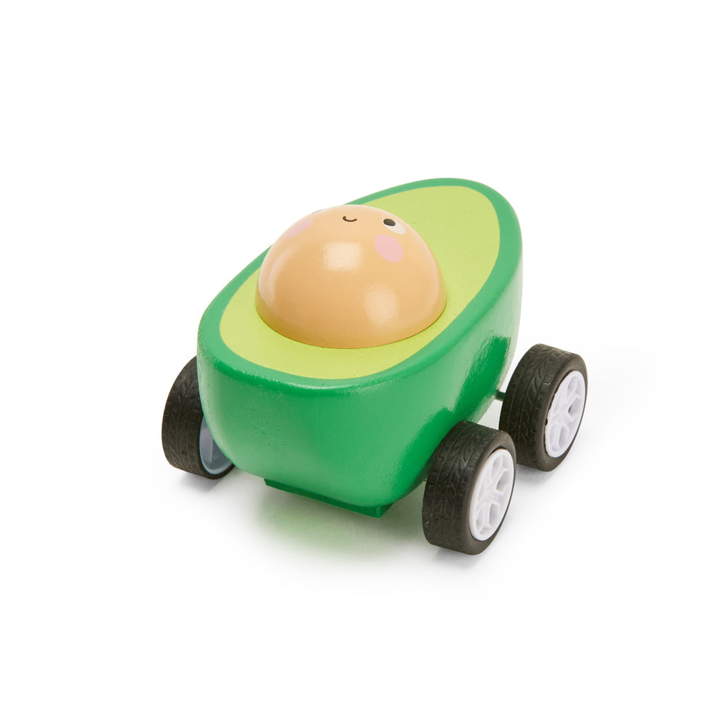 Toy car shaped like a cheerful avocado with a smiling pit face. The green body has four black wheels. Playful and whimsical tone.
