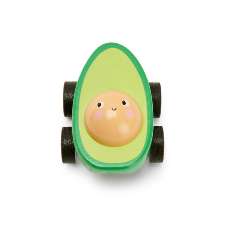 Toy car shaped like a cheerful avocado with a smiling pit face. The green body has four black wheels. Playful and whimsical tone.