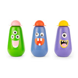 Three colorful, cone-shaped toy figures with playful monster faces: a green one with three eyes, a blue one with big teeth, and a purple one with a single eye.
