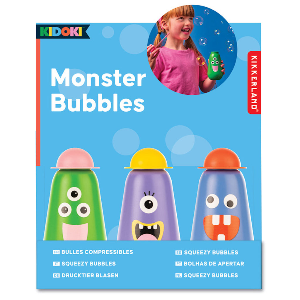 Colorful packaging for "Monster Bubbles" by Kikkerland features three whimsical monster bubble bottles with silly faces. A child is shown joyfully blowing bubbles.