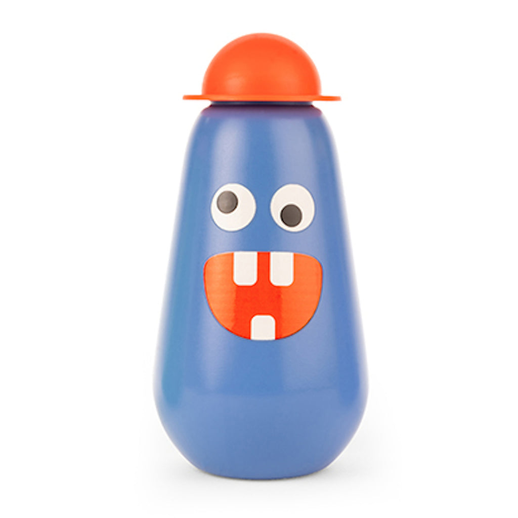 Blue bottle with a playful monster face, including big eyes and a wide-toothed smile. Topped with a round orange cap, conveying a whimsical tone.