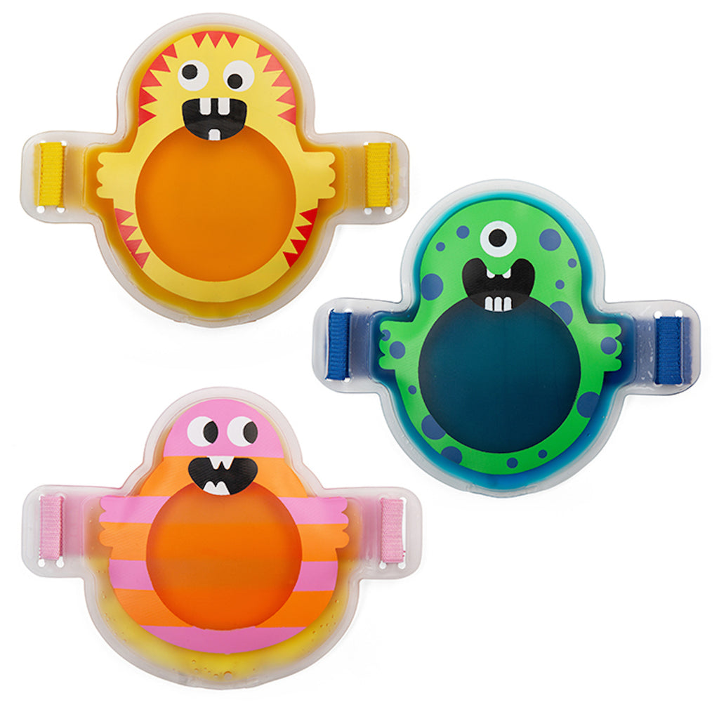 Three colorful cartoon monster-shaped gel packs with adjustable straps: a yellow-red, a green-blue, and a pink-orange design, each smiling playfully.