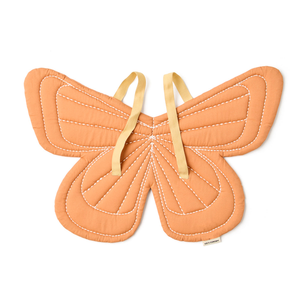 Orange butterfly-shaped quilted costume with white stitching details and yellow fabric straps, conveying a playful and whimsical tone.