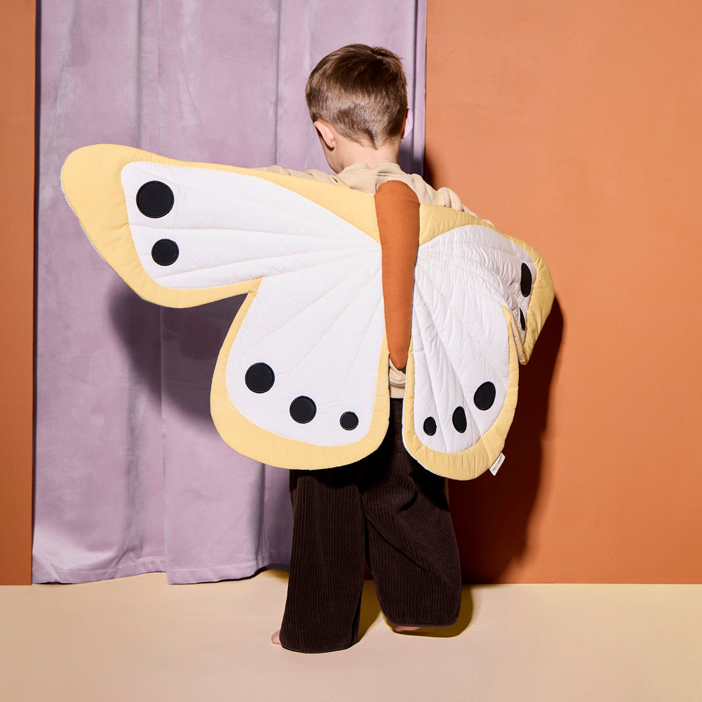 A cheerful yellow butterfly-shaped costume featuring black dots, perfect for imaginative play and decoration.