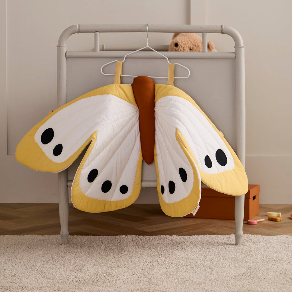 A cheerful yellow butterfly-shaped costume featuring black dots, perfect for imaginative play and decoration.